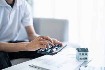 Man calculate finances home pay bills taxes savings economy financial at home
