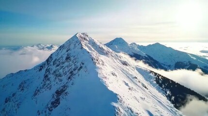 Majestic Snowy Mountain Peak Enveloped in Misty Clouds with Dramatic Lighting and Shadows