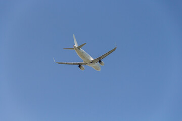 A passenger plane flies in the sky. A passenger plane from below.