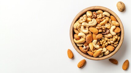 Fototapeta premium A wooden bowl filled with a variety of mixed nuts on a light background.