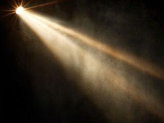 Obraz premium A beam of light shining down from the top left corner, with a black background.The beam is white in color, and its rays spread out to form an oval shape. There are some dust particles floating around 
