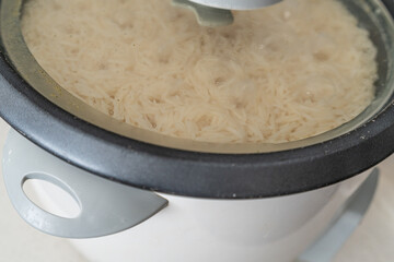 Electric rice cooker appliance boiling white rice