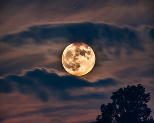 Full Moon Night Sky with a full moon in a nice cloudy sky overcast, with thick clouds covering the sky.