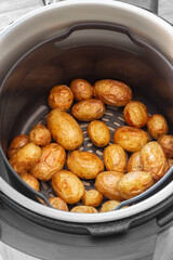 Roasted whole baby potatoes cooked in an air fryer. Fast healthy cooking concept