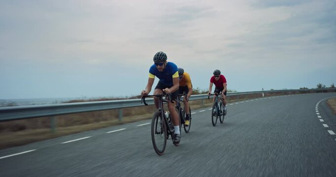 Professional Cycling Team Racing on a Seaside Road, Showcasing Endurance and Teamwork. Cyclists, Wearing Helmets and Colorful Jerseys, Drafting Together, Practicing for a Cycling Competition