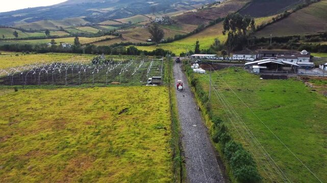 Stunning aerial shot showcasing vibrant a farming setting, roads, and the serene beauty of rural landscapes of romerillo sector, Machachi parish, Mejia canton, Pichincha, Ecuador and Rumi&ntilde;ahui volcano