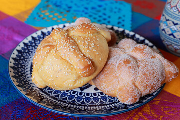 Traditional Pan de Muerto on a colorful tablecloth