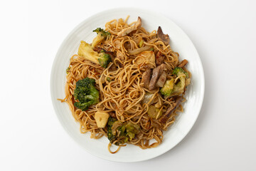 Stir-fried Hong Kong-style egg noodles on a white background