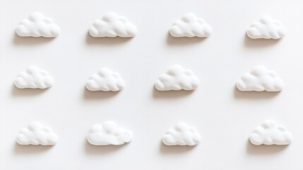 A pattern of white cloud shapes on a light background, suggesting a playful, whimsical design.