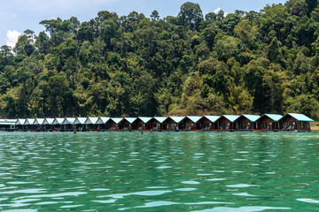 Tourist glamping hotel houses floating in the lake in Thailand