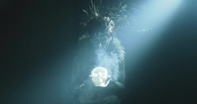 The witch holds a skull candle 