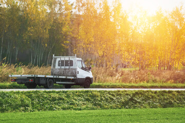 Sunset drive with a tow truck on a country road