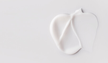cosmetic smears of creamy texture on gray background