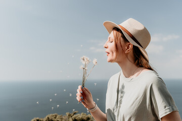 Woman in a Straw Hat Blowing Dandelion Seeds