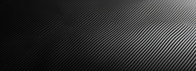 Obraz premium Black carbon fiber background with diagonal lines, minimalistic style, high-resolution design for seamless tiling in web design and graphic arts.