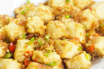 Stirred Tofu: Vegetarian Asian Style.This vibrant dish features crispy stir-fried tofu, perfectly marinated for flavor and texture. The tofu is coated in soy sauce and sesame oil, a rich umami taste.