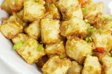 Stirred Tofu: Vegetarian Asian Style.This vibrant dish features crispy stir-fried tofu, perfectly marinated for flavor and texture. The tofu is coated in soy sauce and sesame oil, a rich umami taste.