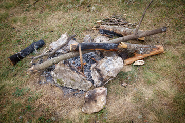 A pile of wood and rocks with a fire pit in the middle