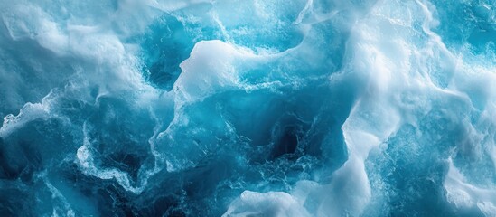 Obraz premium Abstract close-up of blue ice and snow, a view from inside an ice cave with light filtering through the ice.