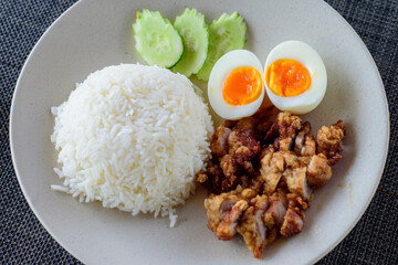Crispy Pork and Orsen Egg with Thai jasmine rice, in white plate, 