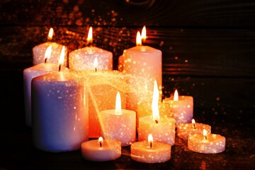 Burning candles surface in darkness background