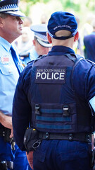 Sydney, NSW Australia - October 6 2024: crime in sydney. Close up of a NSW Police officers uniform sleeve patch and his communication device. australia police