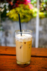 a cup of cold cappuccino iced coffee served in a cafe