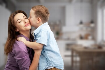 Caring young mother preparing child for school
