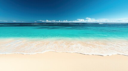 Obraz premium A tranquil beach with clear turquoise water gently lapping onto soft, white sand under a blue sky with scattered clouds.