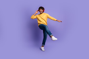 Photo of funky cool nice man wear trendy yellow clothes listen music dance isolated on purple color background