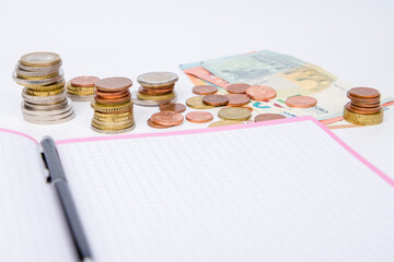 money coins with note book and pen, business concept