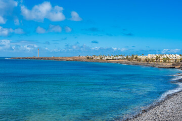Coastal strip on Playa Blanca to the Faro de Punta Pechiguera lighthouse