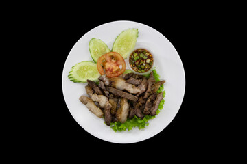 Grilled marinated beef with spicy dipping sauce top view isolated on black background with clipping path
