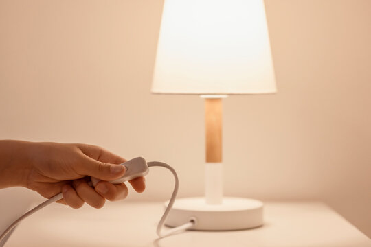 Turn off Light. Switch off the Light. Saving Energy by Turning off the Lights of Table Lamp.