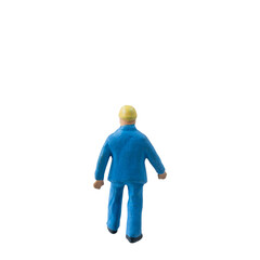 Miniature construction worker dressed in a blue jumpsuit isolate on white background with clipping path