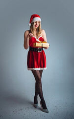 Miss Santa Claus with a gold gift, Christmas concept