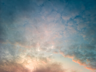 The rays of the sun breaking through the dramatic clouds in the evening or in the morning in the sunset or sunrise sky.