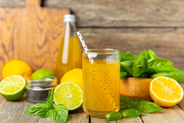 Fototapeta premium Diet detox cocktail with basil and chia seeds in a glass jar and a glass on a textured background. Drink with seeds. Health food. Detox cocktail. Antioxidant. Water with basil. Space for text. 