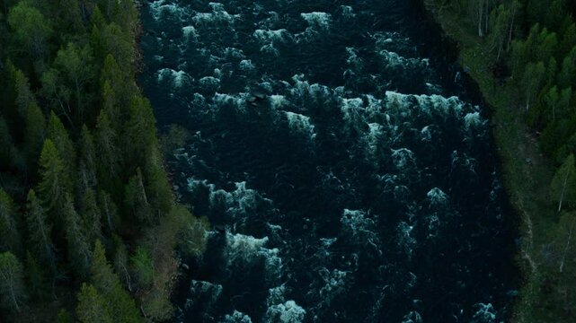 River with fast water and trees on the sida