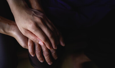 Close-up of Holding mother's hand. Love and relationship with care