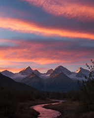 Landscape featuring a mountain range with snow-capped peaks under a vibrant, colorful sky during sunset or sunrise