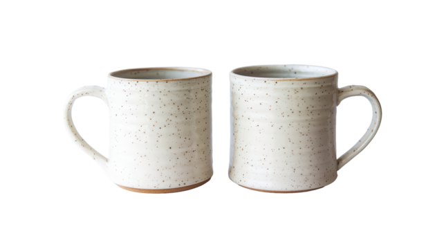  A side view of two empty white coffee mugs isolated on transparent background. 