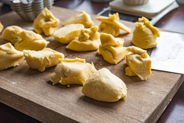 Brioche dough and mold on the wooden cutboard before sending in the oven.