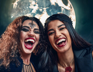 A group of friends posing at a Halloween party. They put on their makeup and dressed in Halloween concept