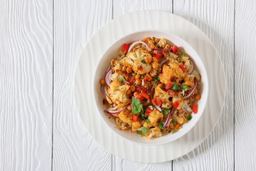 cauliflower chickpea quinoa salad in a white bowl