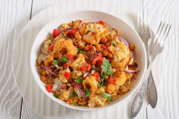 cauliflower chickpea quinoa salad in a white bowl