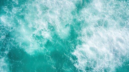 Fototapeta premium Waves crash onto a turquoise ocean, creating a breathtaking scene of nature's power and beauty, with the vibrant colors and dynamic motion capturing the eye.
