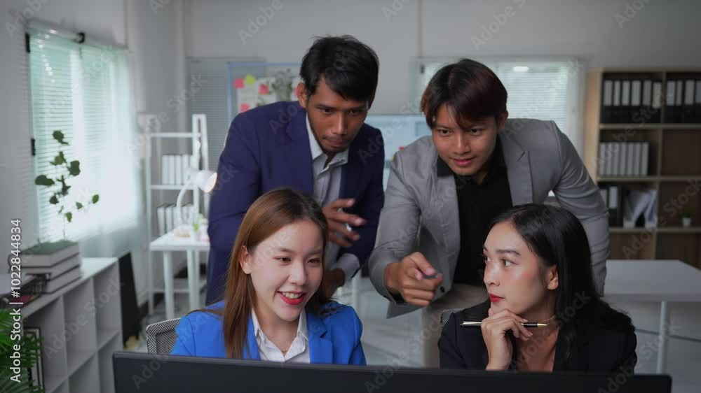 Aufkleber business team collaborates on a project, engaging in a lively discussion around a computer in their 