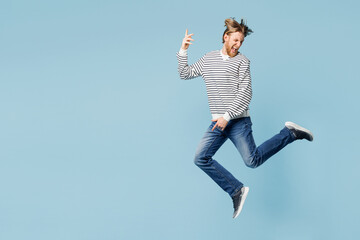 Full body young happy singer man he wear striped sweatshirt casual clothes jump high play air...