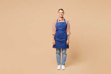 Full body young smiling happy woman barista bartender barman employee she wear blue apron red shirt...